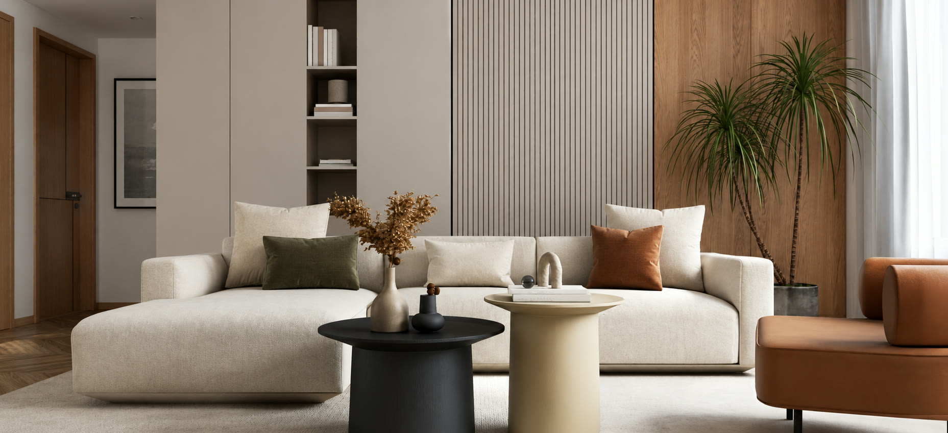 A cream sectional sofa with round coffee tables in a minimalist living room